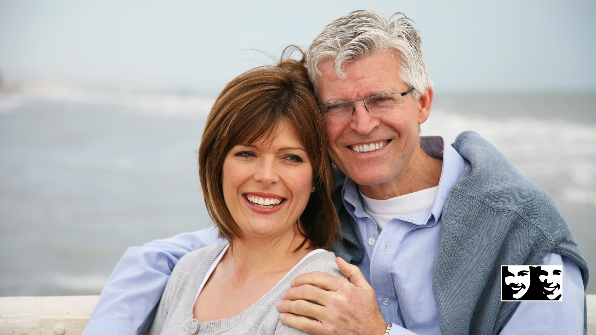 A man and a woman are posing for a picture and smiling