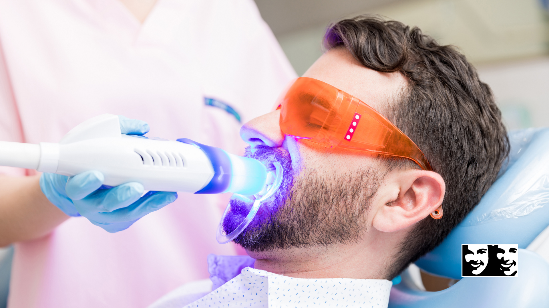 A man is getting his teeth whitened in a dental office.