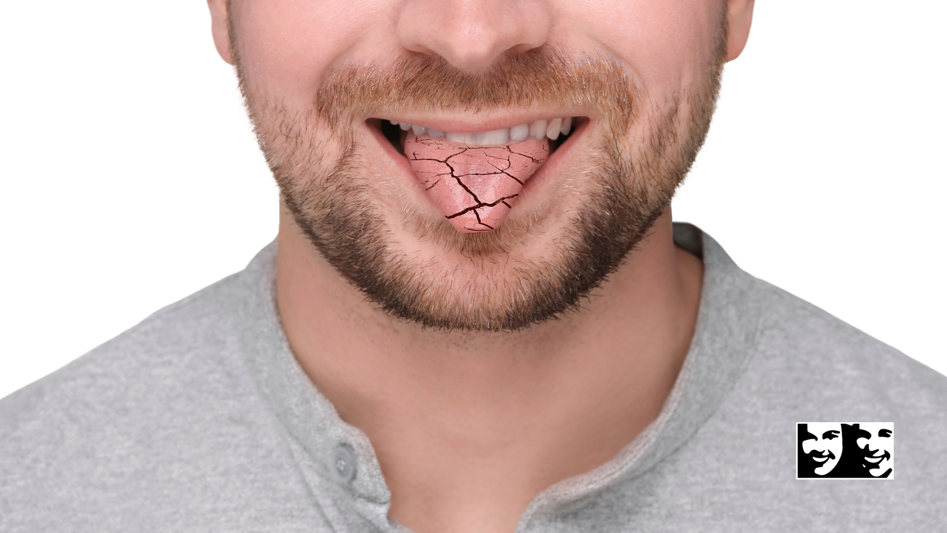 A man with a beard is smiling with his tongue out