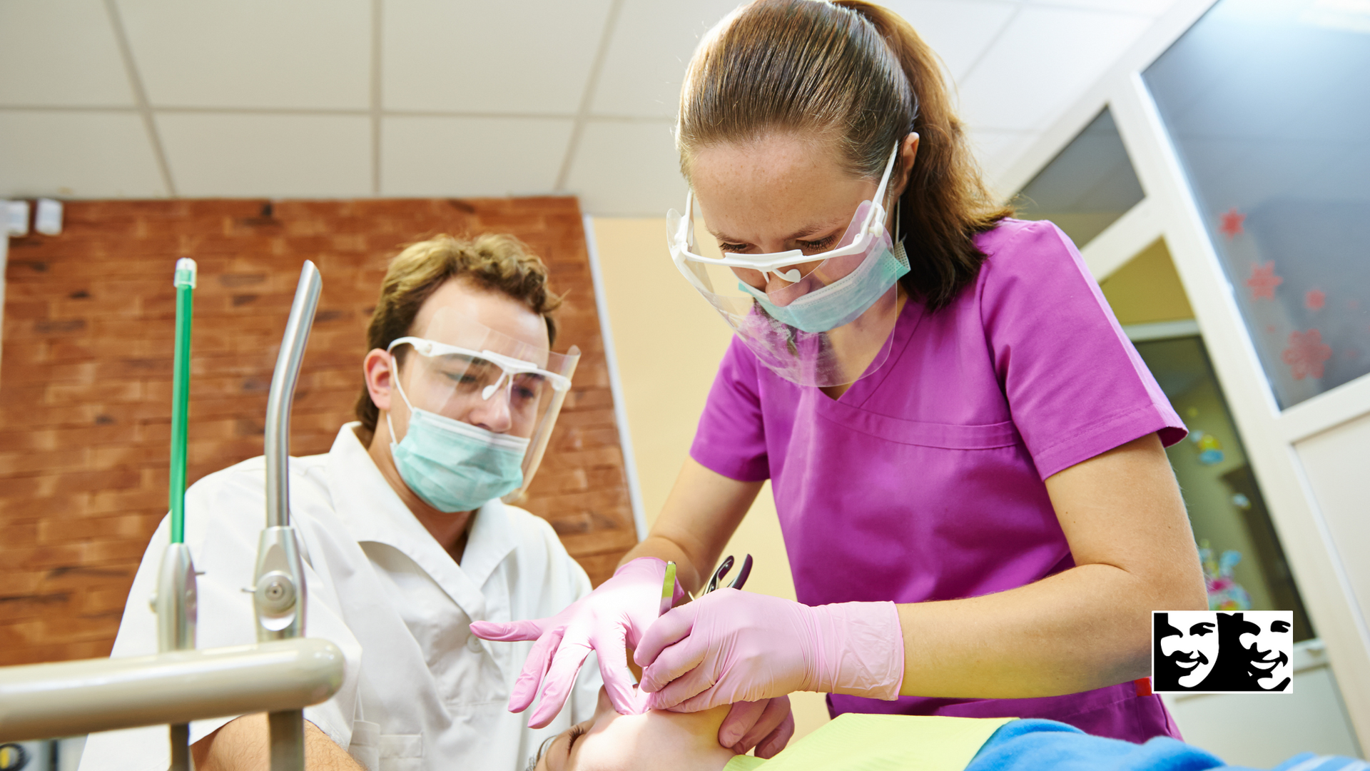A dentist and a nurse are working on a patient 's teeth.