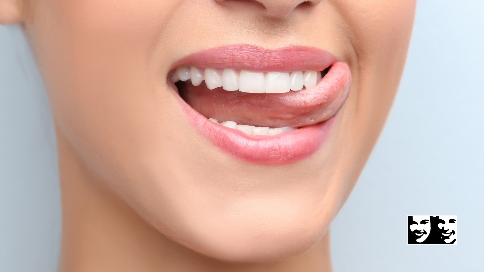 A close up of a woman 's face with her tongue sticking out.