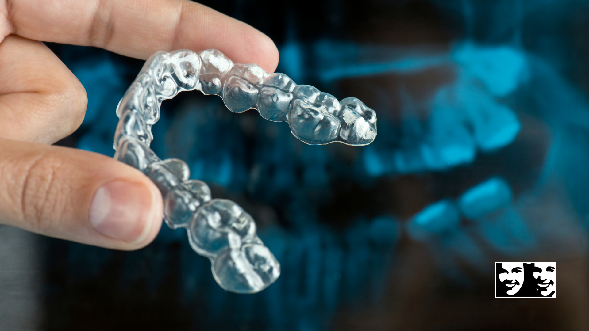 A person is holding a clear brace in their hand.