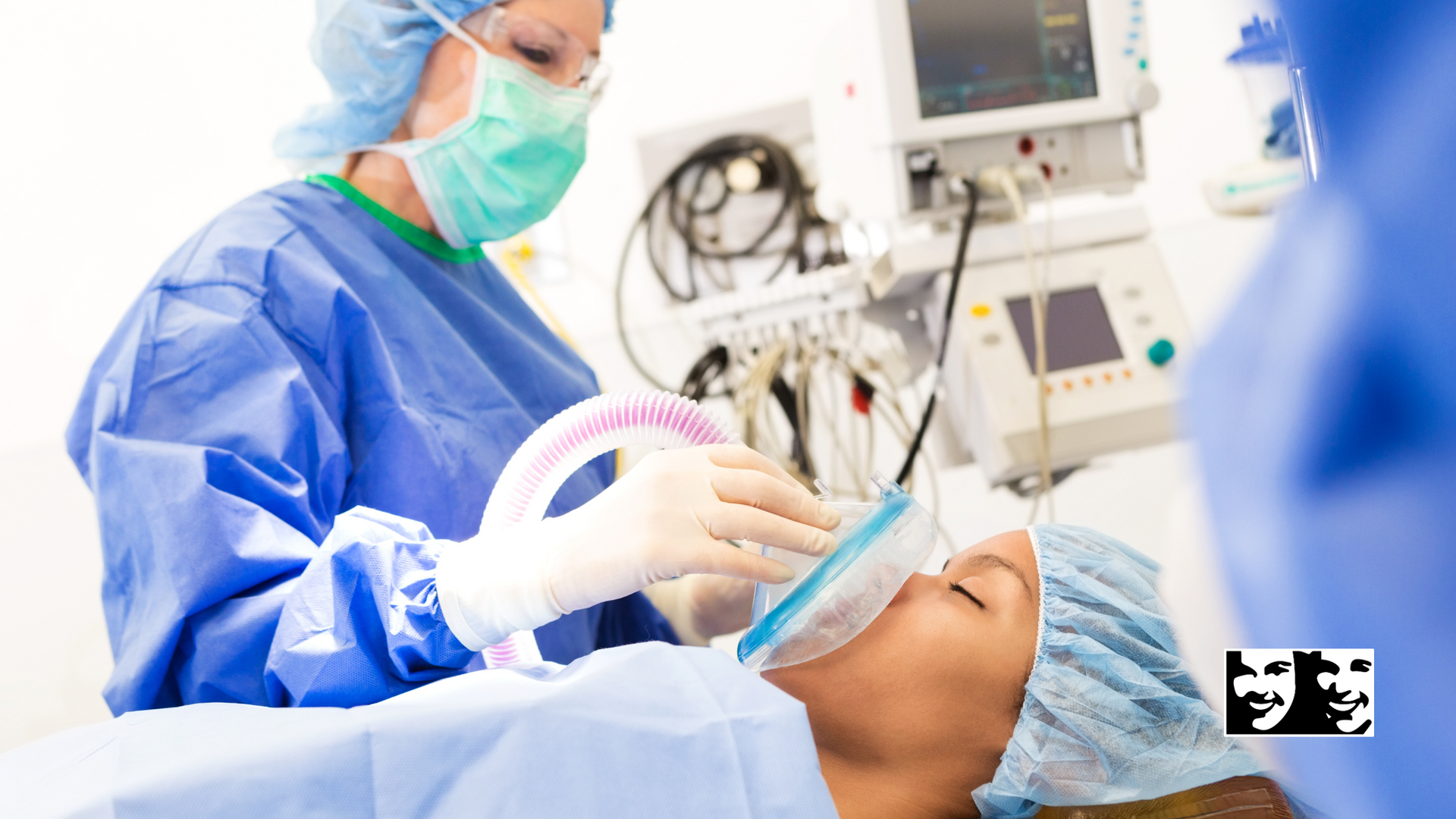 A surgeon is putting an oxygen mask on a patient in an operating room.