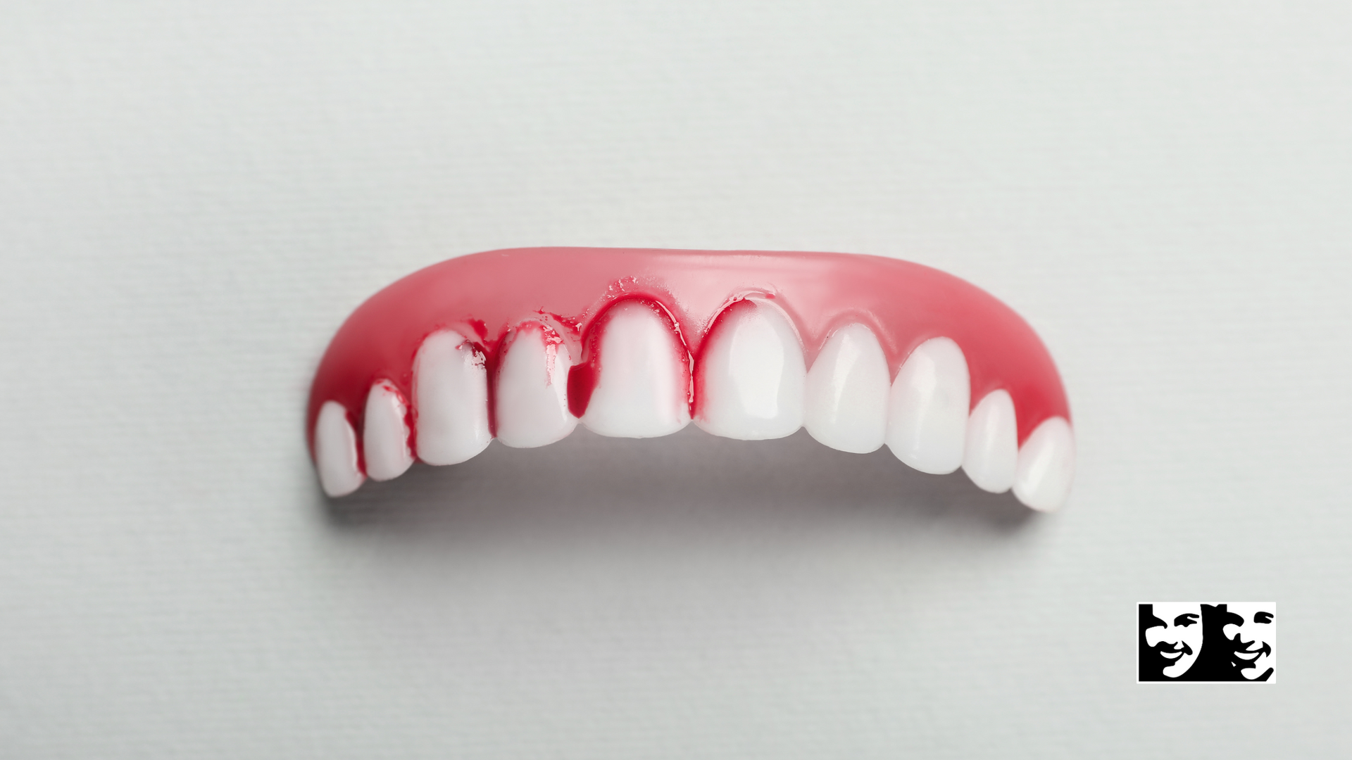 A close up of a fake teeth on a white surface.