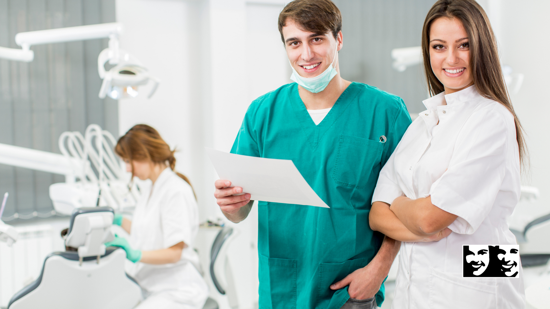 A man and a woman are standing next to each other in a dental office.