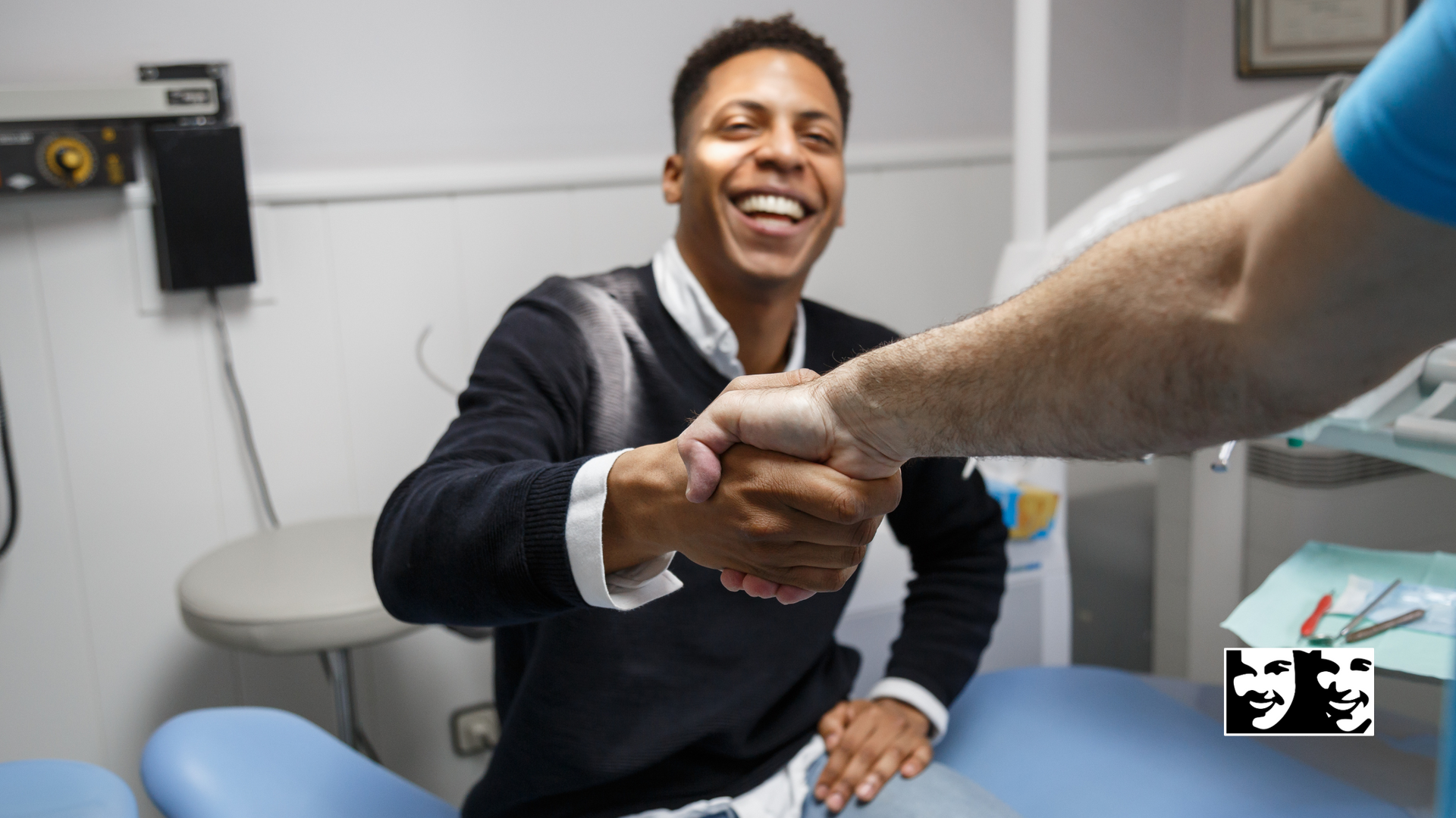 A man is shaking hands with a dentist in a dental office