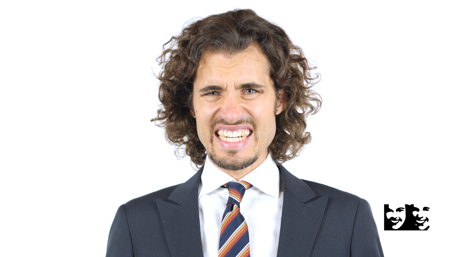 A man in a suit and tie is making a funny face