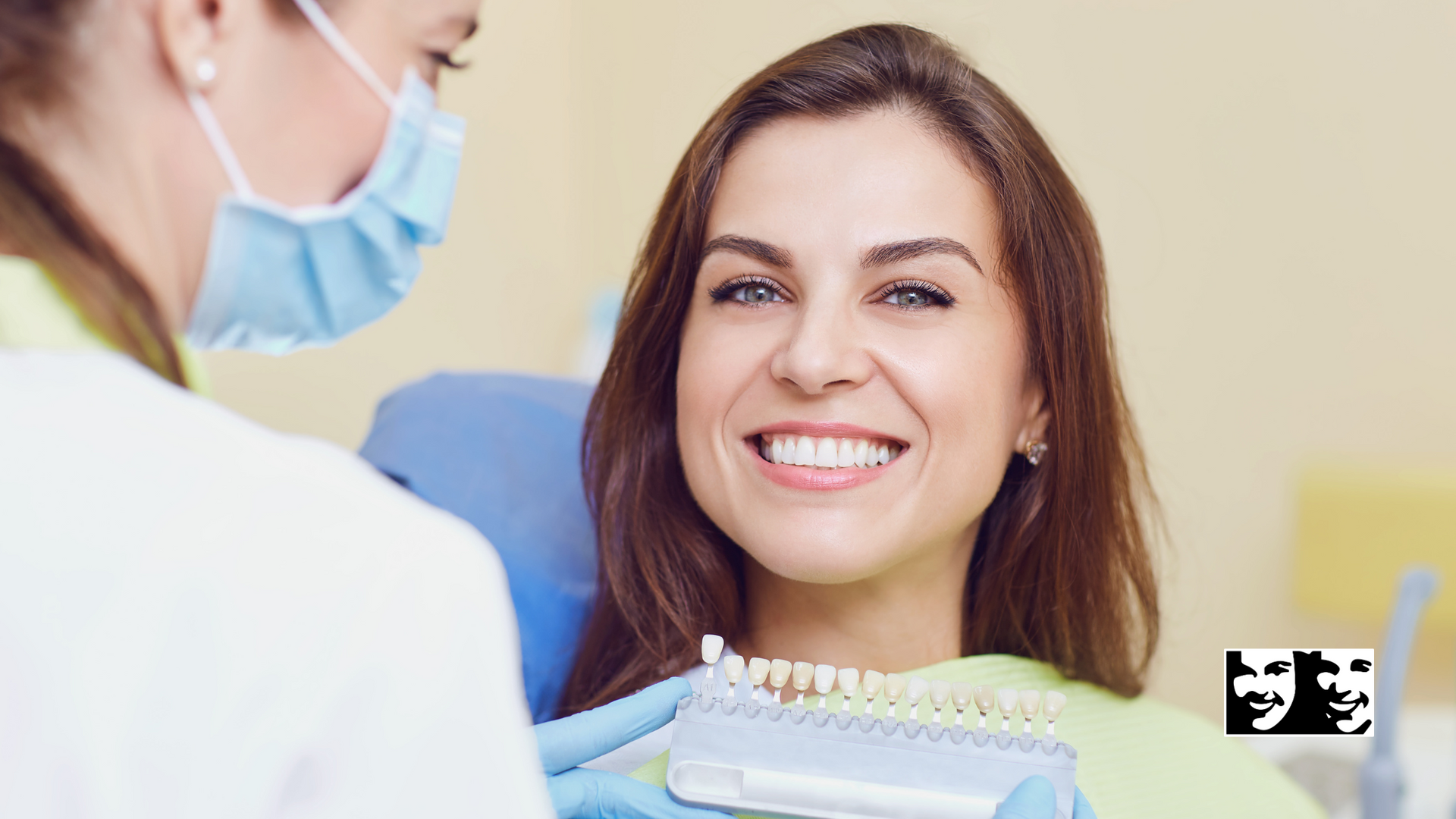 A woman is smiling while sitting in a dental chair while a dentist examines her teeth.