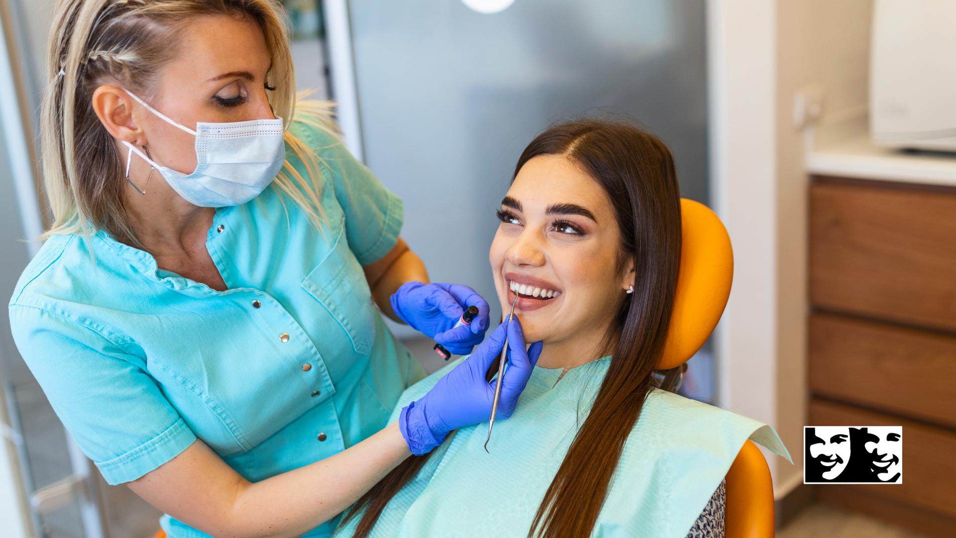 A woman is sitting in a dental chair while a dentist examines her teeth.