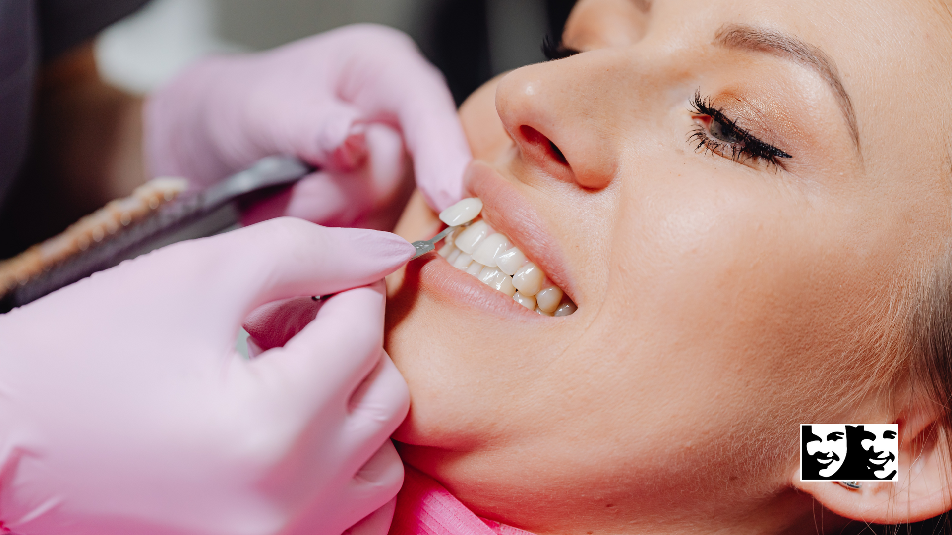 A woman is getting her teeth examined by a dentist.