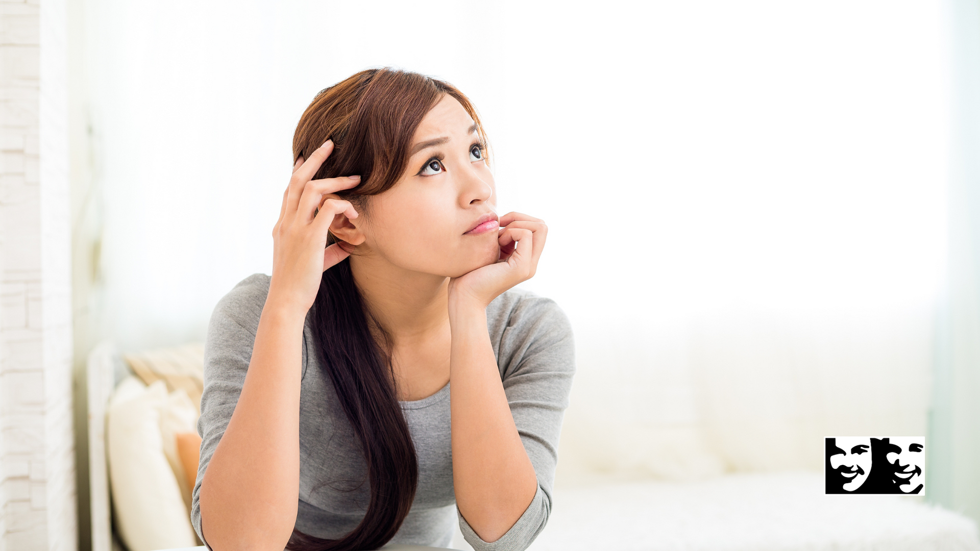 A woman is sitting on a couch looking up at the sky.