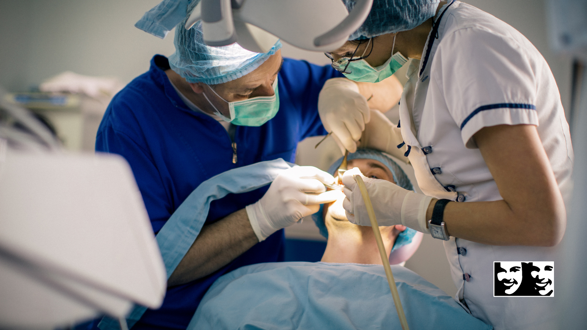 A dentist and a nurse are working on a patient 's teeth.