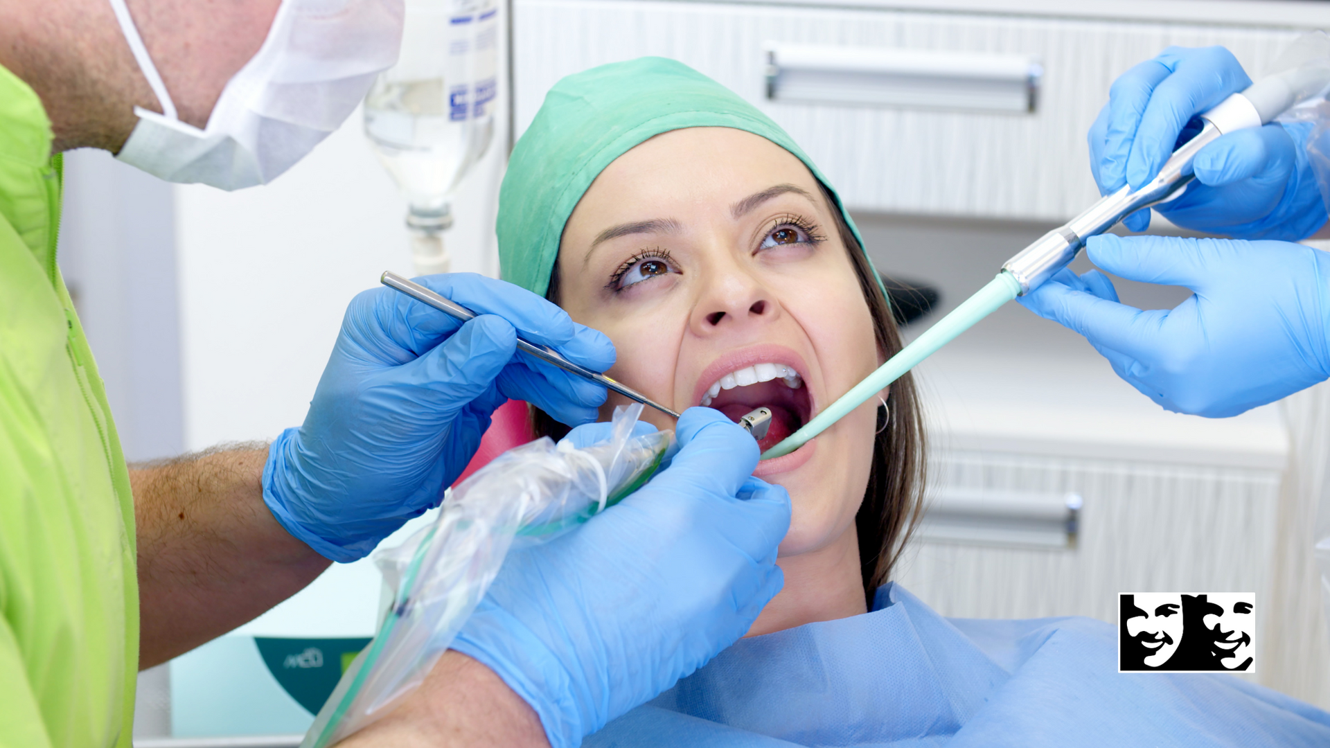 A woman is getting her teeth examined by a dentist.