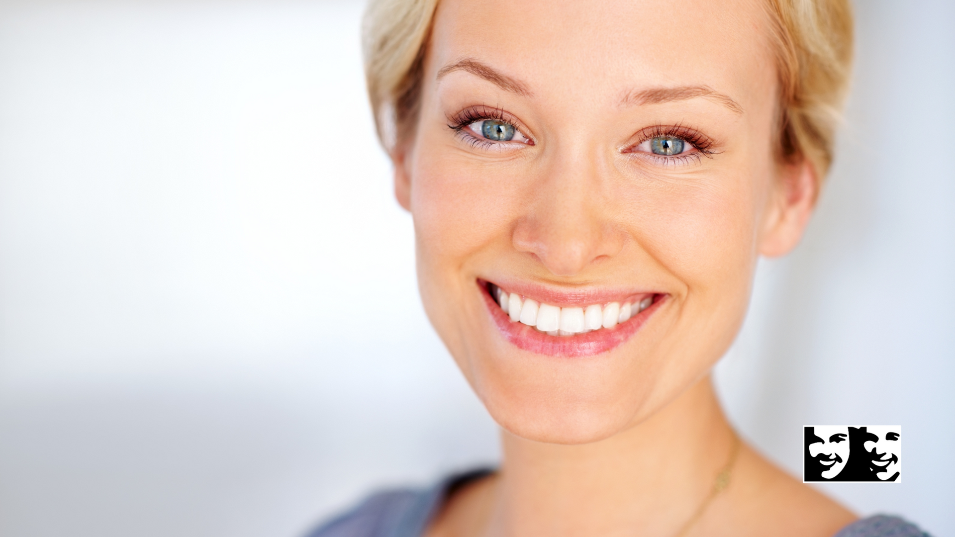 A close up of a woman 's face with a smile on her face.