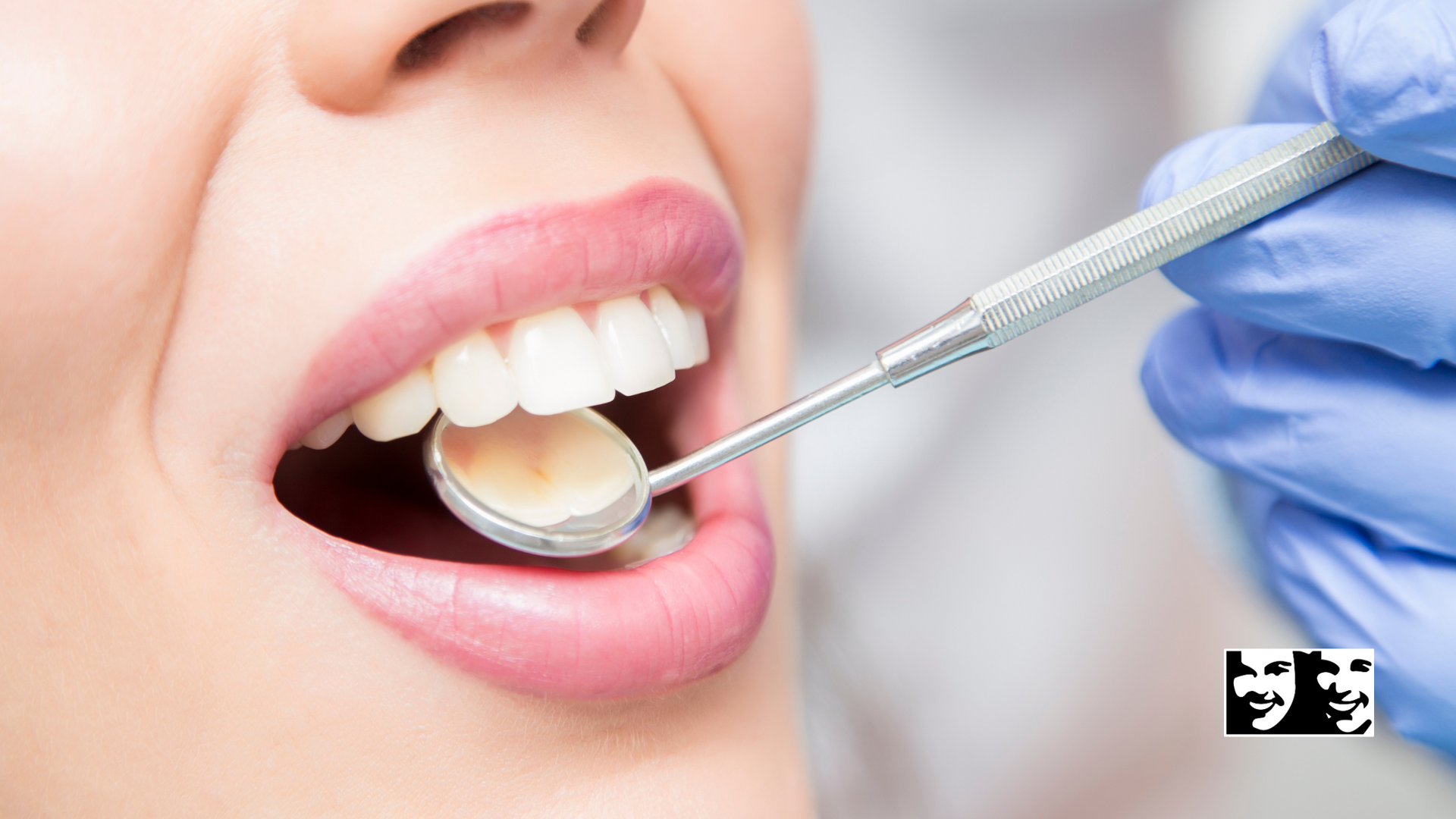 A woman is getting her teeth examined by a dentist.