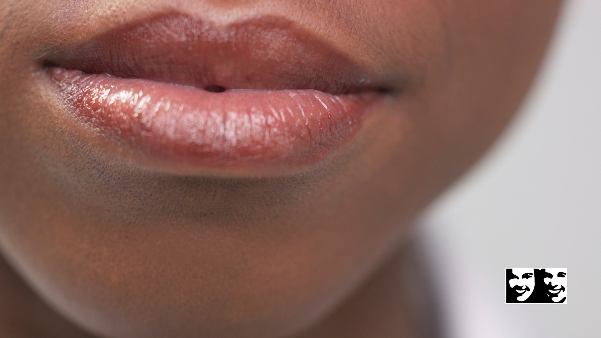 A close up of a woman 's lips with lipstick on