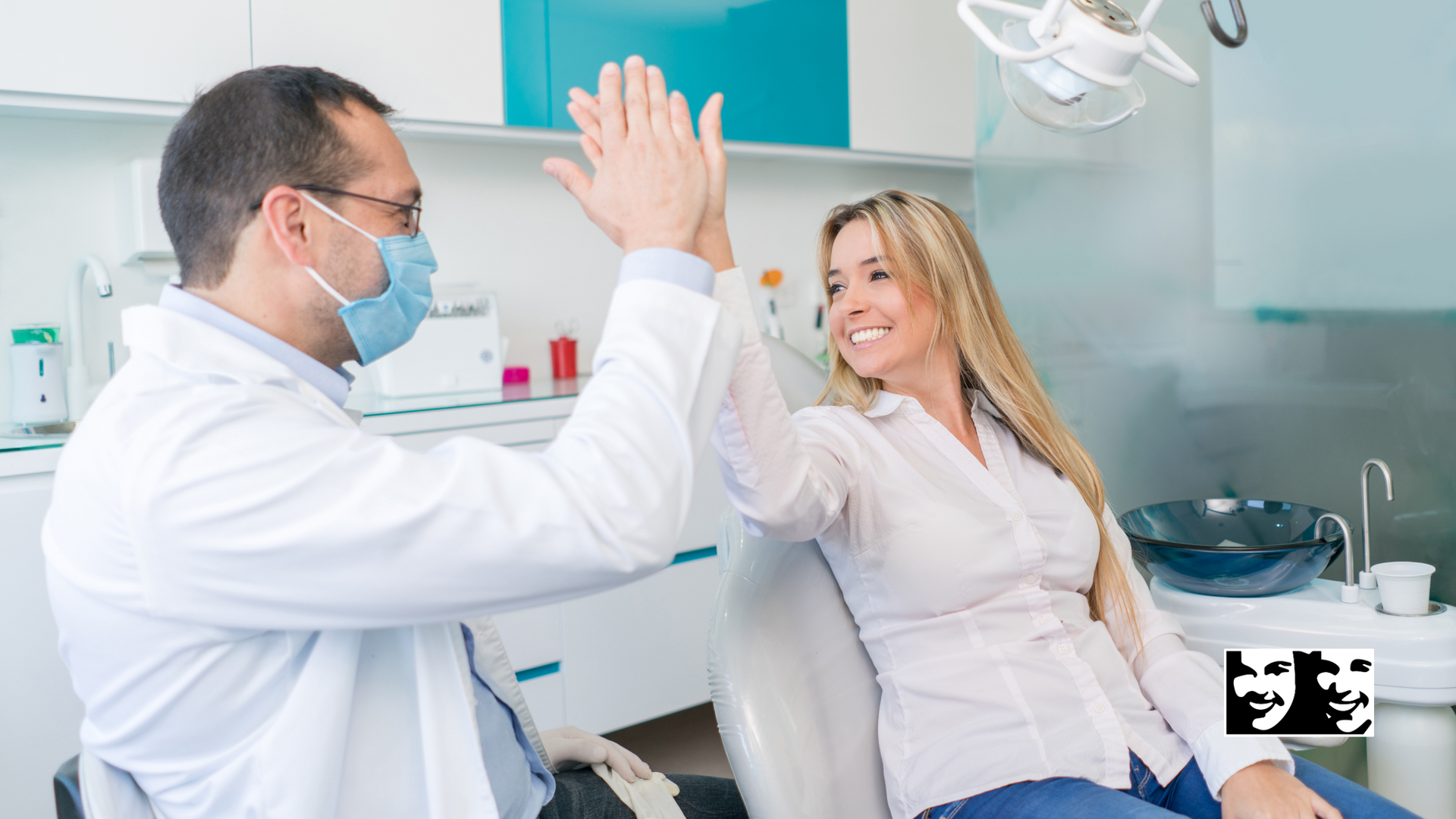 Dentist in mask and patient give high five, in dental office.