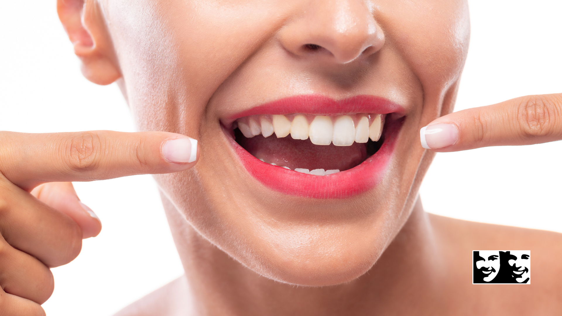A woman is pointing at her teeth with her fingers.