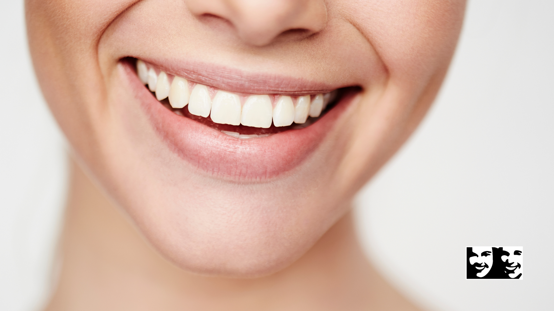 A close up of a woman 's smile with white teeth.