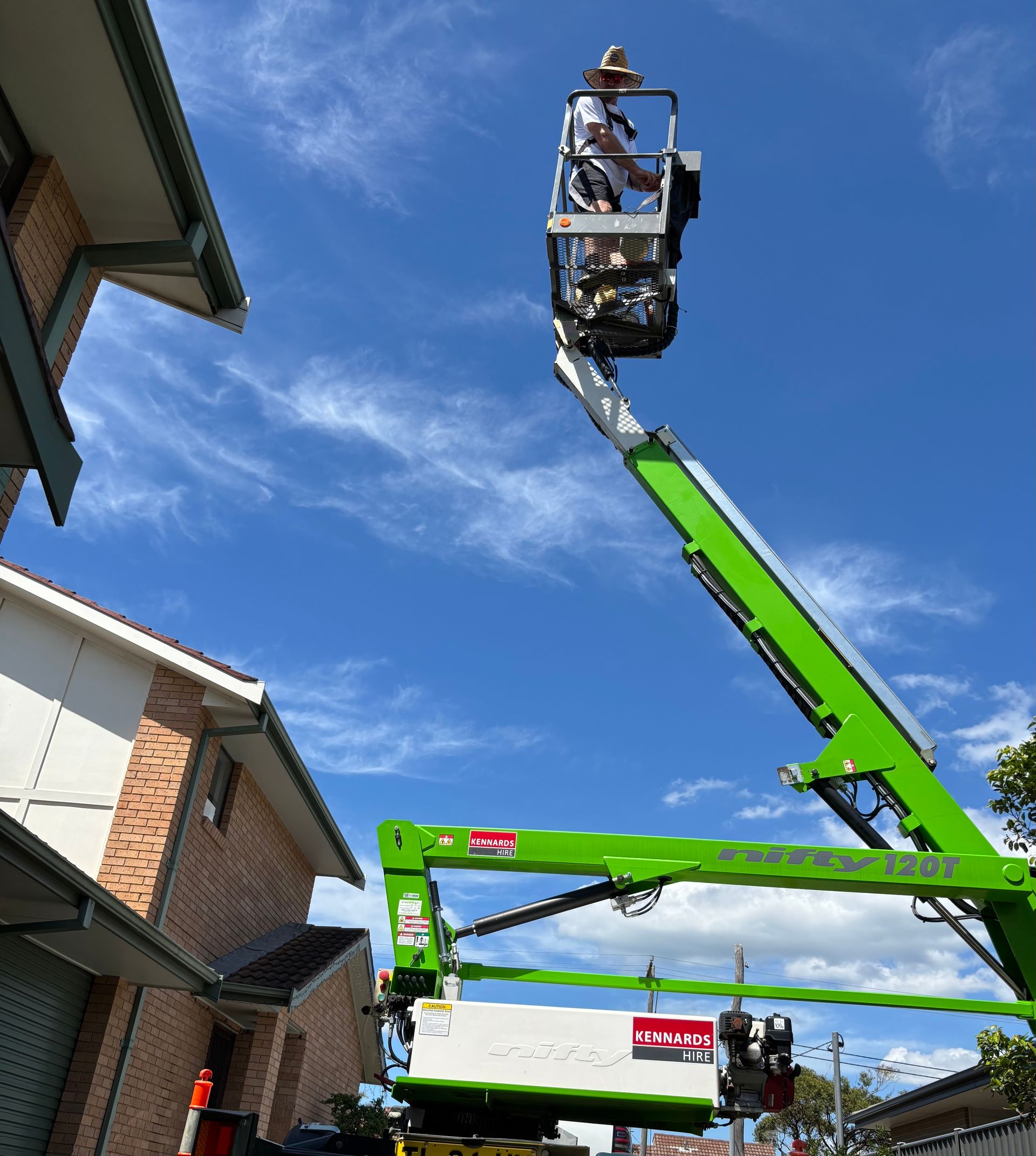 A Man is Working on the Roof of a Building — Timeless Painting In Terrigal, NSW