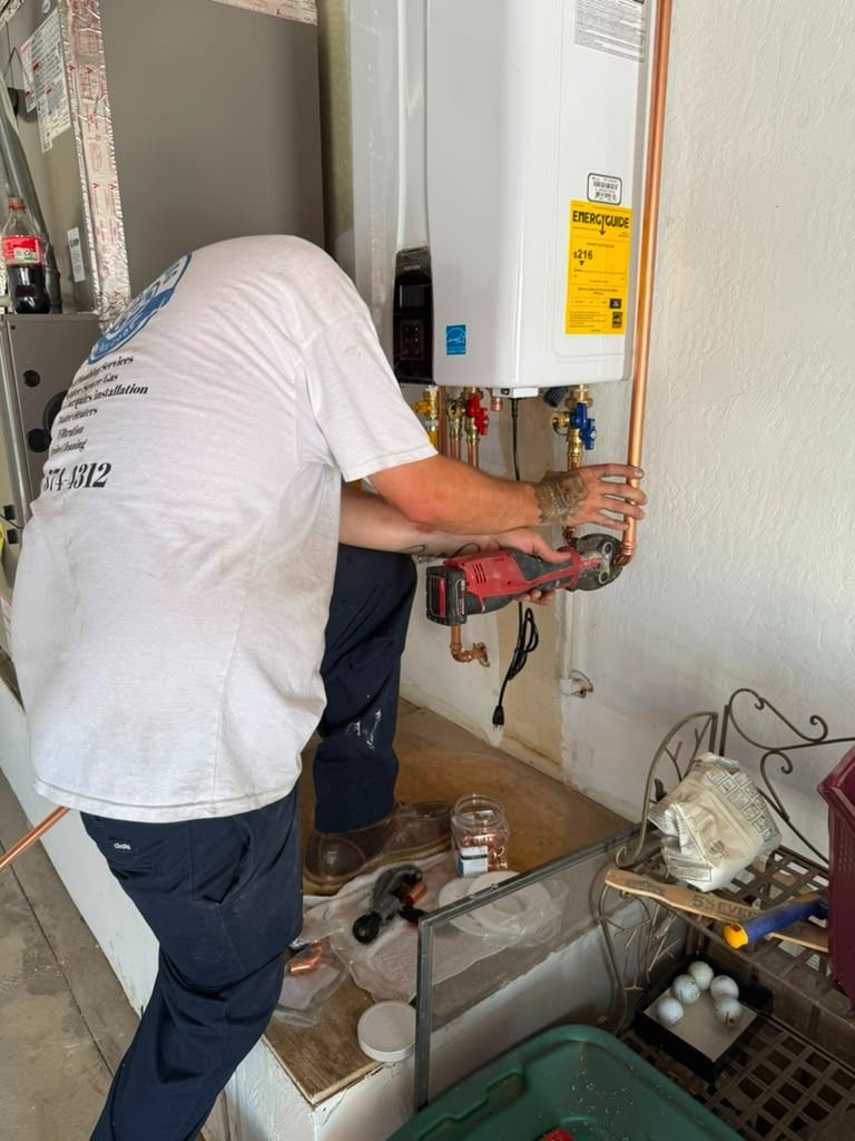 Technician repairing a wall-mounted water heater with tools in a utility room