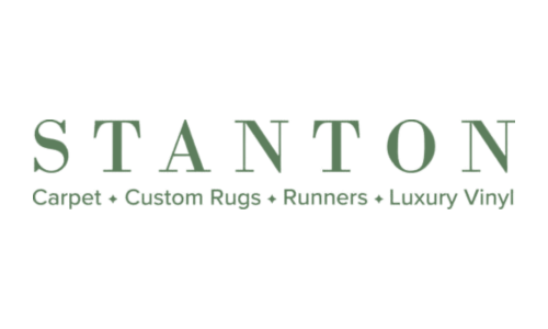 The logo for stanton carpet , custom rugs , runners , and luxury vinyl.