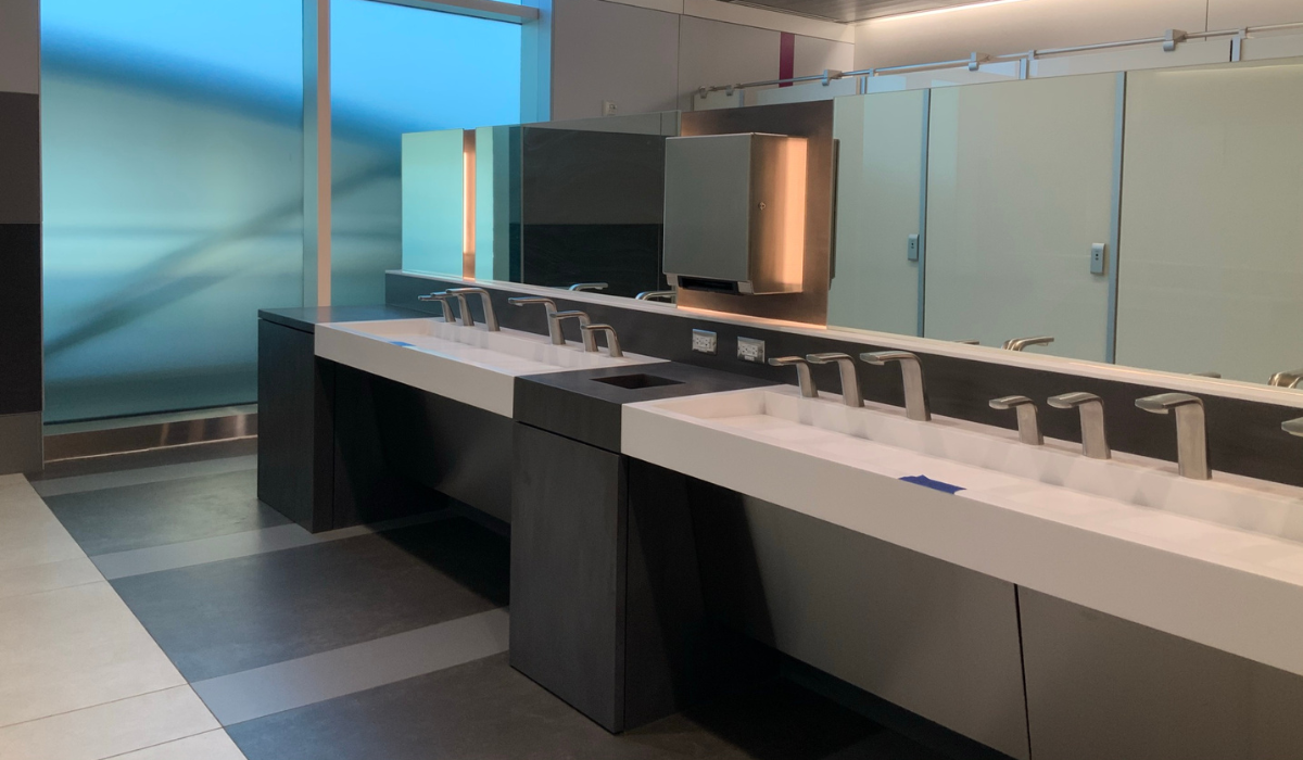 A bathroom with two sinks and a large mirror.