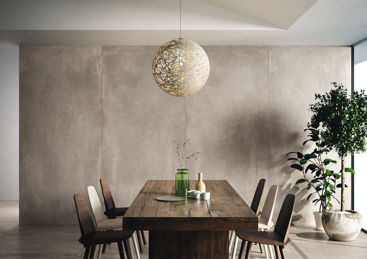 A dining room with a long wooden table and chairs.