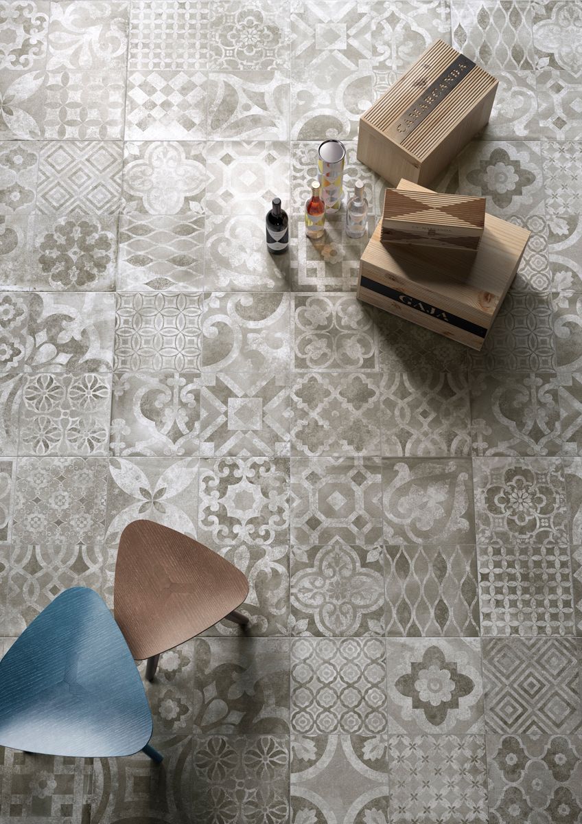 A chair is sitting on a tiled floor next to boxes.