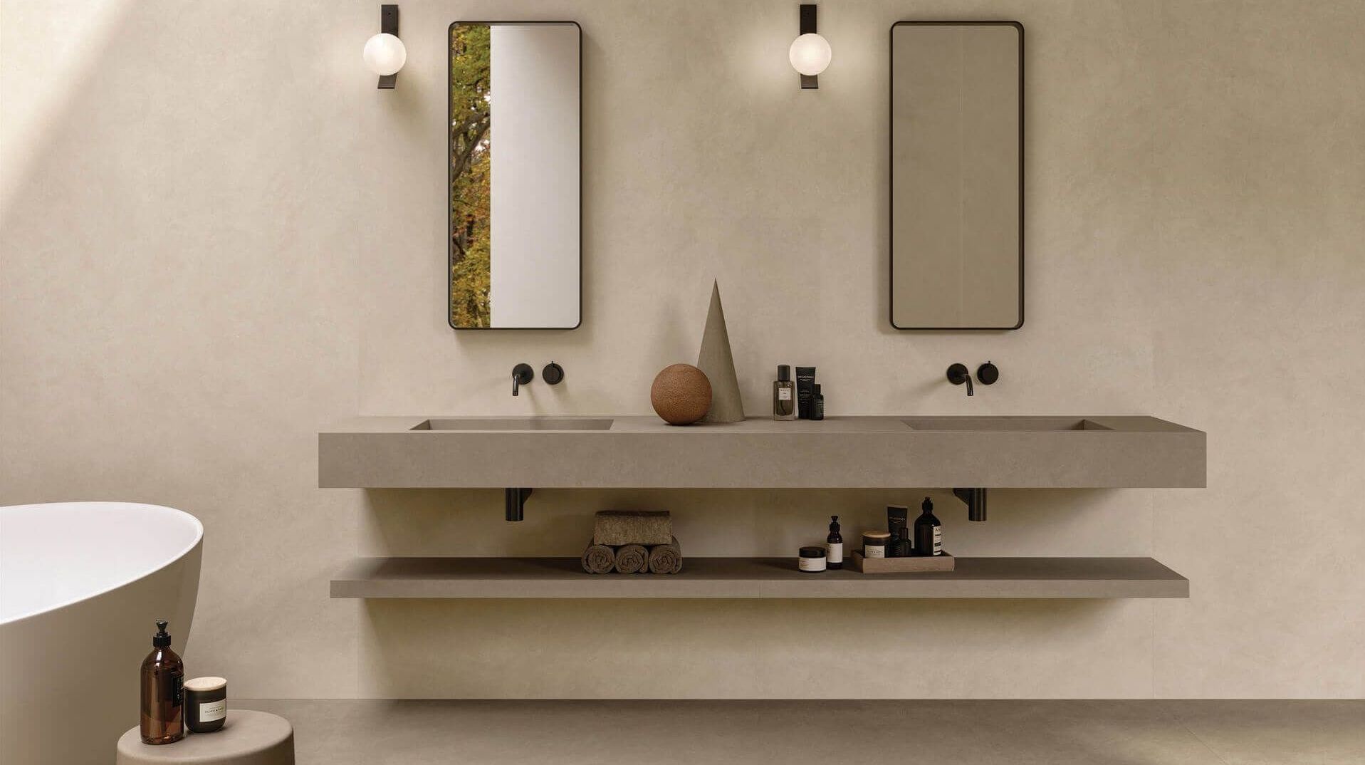 A bathroom with two sinks , two mirrors and a bathtub.