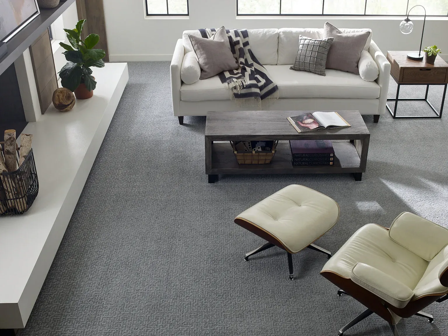 A living room with a couch , chair and ottoman