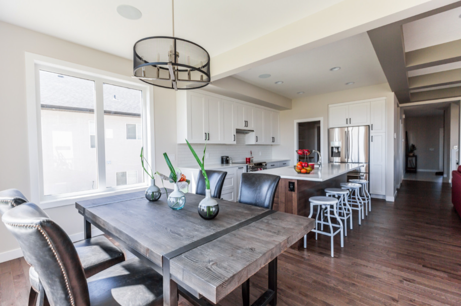 A dining room table and chairs in a kitchen.