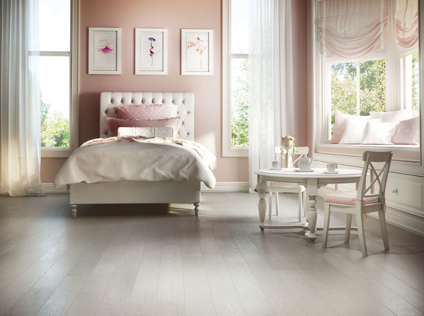 A bedroom with a bed , table and chairs.