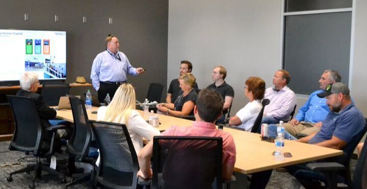 A man is giving a presentation to a group of people in a conference room.