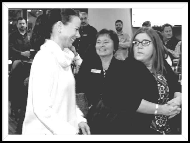 A black and white photo of three women standing next to each other
