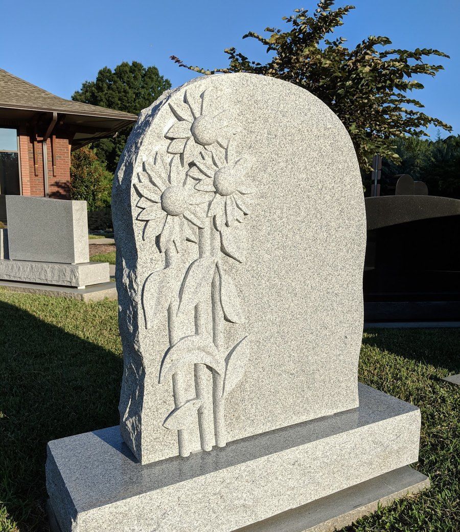 A carved granite upright monument on display outside the Gaulden Monuments showroom in Charlotte, NC