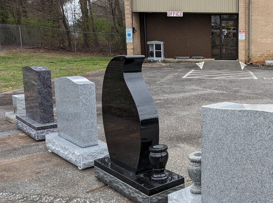 Finished granite uprights and vases in the display yard at the Gaulden Monuments Gastonia showroom on Tulip Drive