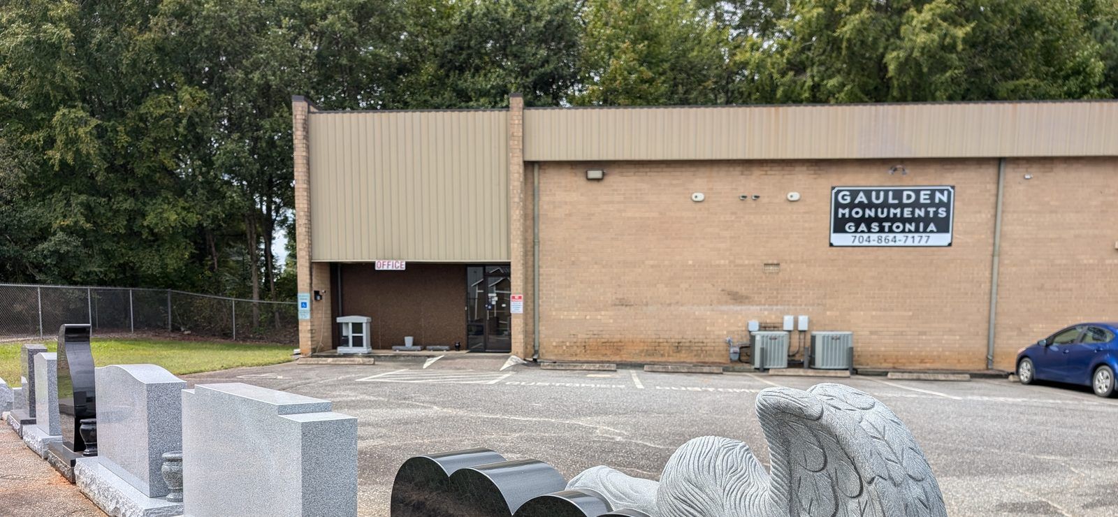 The Gaulden Monuments Gastonia showroom on Tulip Drive, with the Gaulden Monuments Gastonia sign on the building and granite monuments in the lot