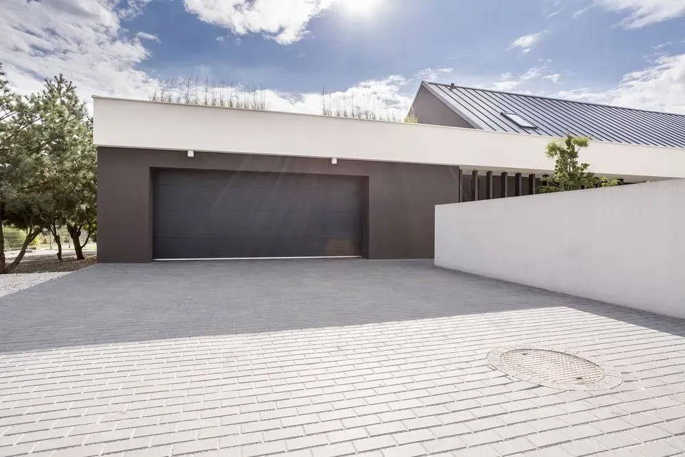 Modern House Exterior with A Large Dark Garage Door — Kempsey Concrete Contractors PTY LTD In South West Rocks, NSW