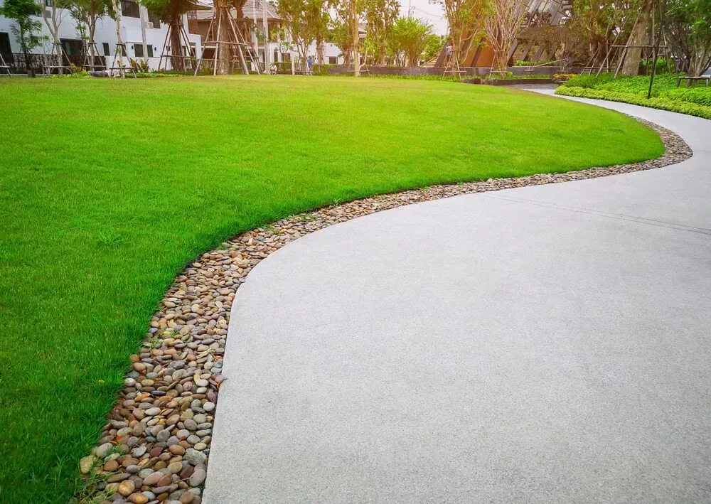 Curved Concrete Path Beside a Bright Green Lawn in A Park — Kempsey Concrete Contractors PTY LTD In Macksville, NSW