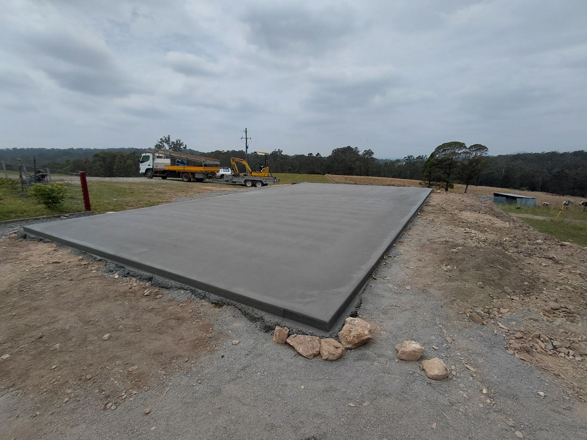Large Concrete Slab Under Construction in A Rural Area with Heavy Equipment — Kempsey Concrete Contractors PTY LTD In Macksville, NSW