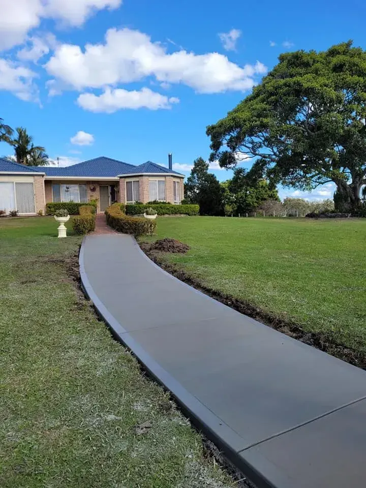 Curved Concrete Walkway Leading to A Single-Story House — Kempsey Concrete Contractors PTY LTD In Dondingalong, NSW