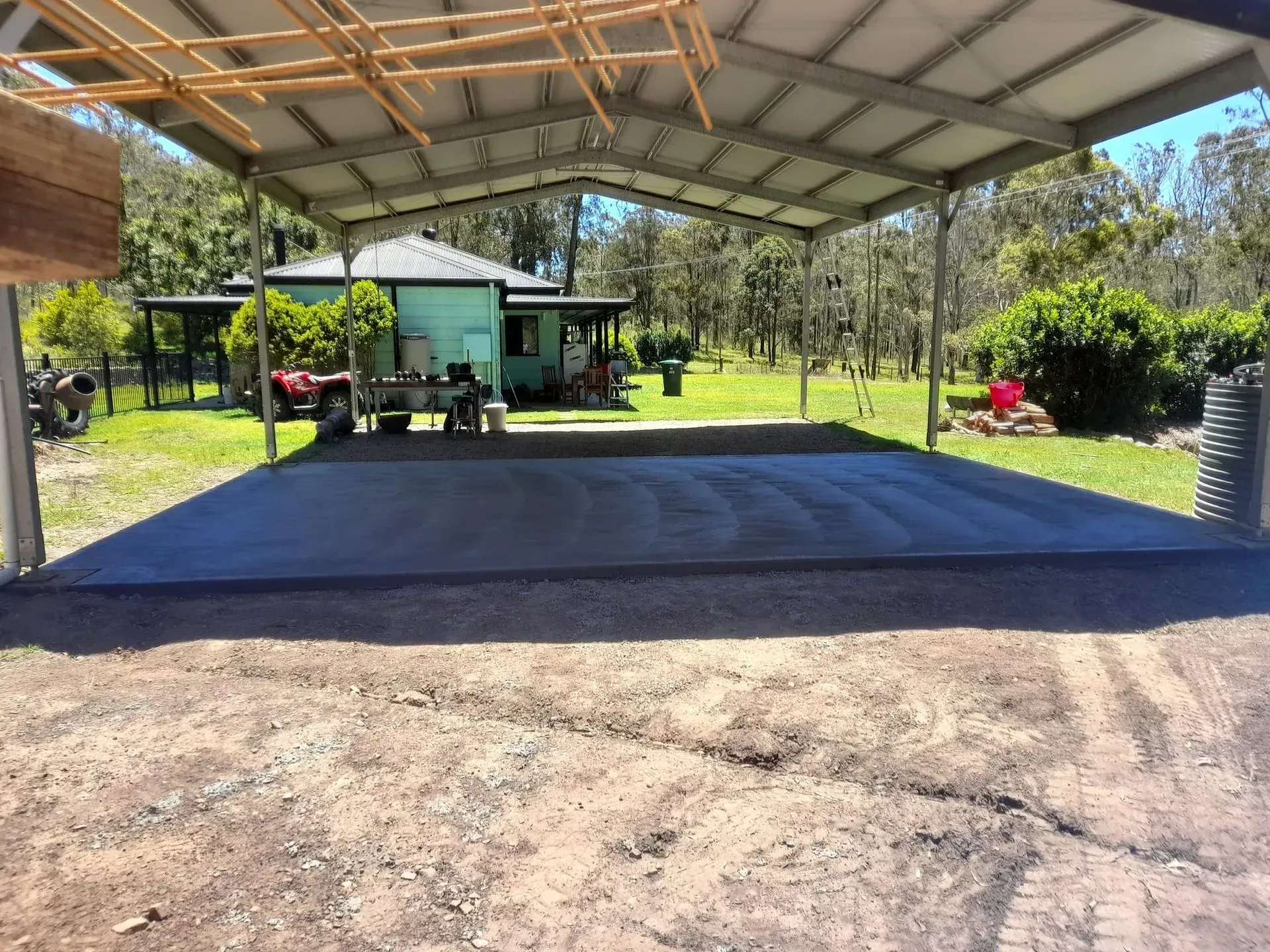 Covered Outdoor Concrete Slab Beside a Green Yard — Kempsey Concrete Contractors PTY LTD In Dondingalong, NSW