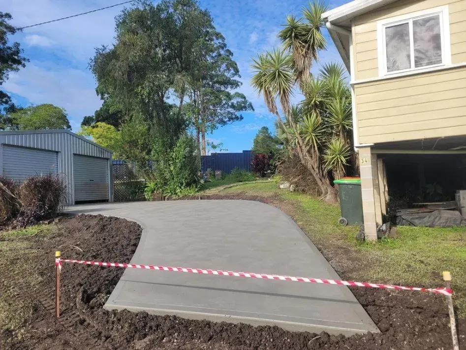 Concrete Driveway Leading to A House, Blocked by Red-And-White Caution Tape — Kempsey Concrete Contractors PTY LTD In Dondingalong, NSW