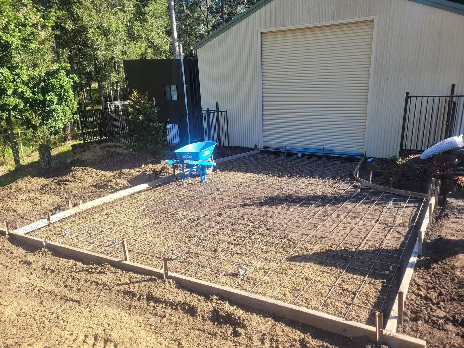 Empty Garden Bed with Wooden Frame Beside a Shed — Kempsey Concrete Contractors PTY LTD In Dondingalong, NSW