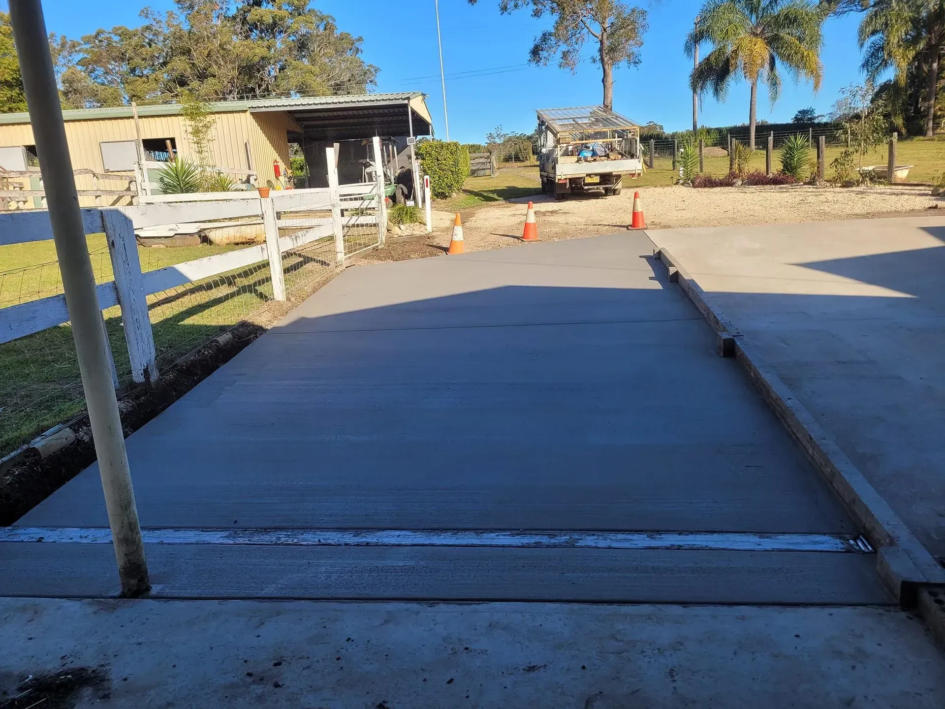 Fresh Concrete Driveway or Ramp Under Construction Beside a Rural House — Kempsey Concrete Contractors PTY LTD In Dondingalong, NSW