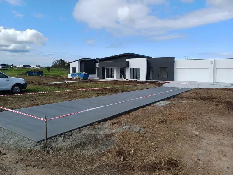 New House with A Long Concrete Driveway Under Construction — Kempsey Concrete Contractors PTY LTD In Port Macquarie, NSW