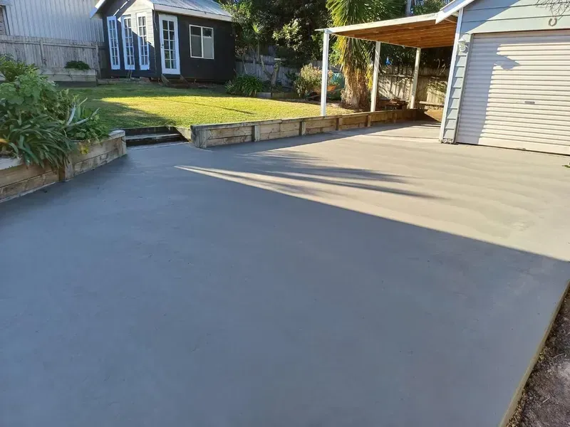 Freshly Poured Concrete Driveway Beside a House — Kempsey Concrete Contractors PTY LTD In Nambucca Heads, NSW