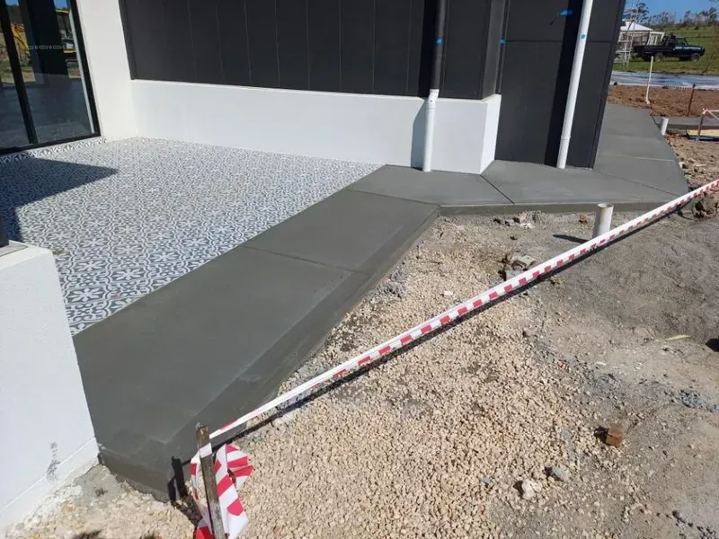 Fresh Concrete Sidewalk Beside a Building — Kempsey Concrete Contractors PTY LTD In Crescent Head, NSW