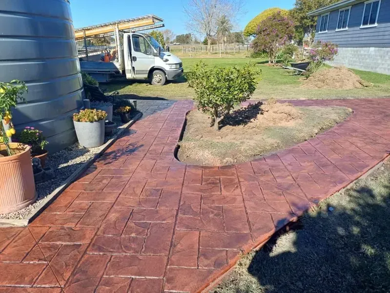 Red Brick Walkway Curving Through a Landscaped Yard — Kempsey Concrete Contractors PTY LTD In Macksville, NSW